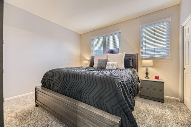 bedroom featuring baseboards and light carpet