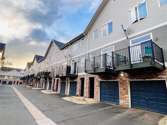 view of building exterior with a residential view and an attached garage