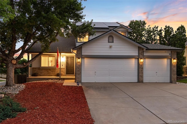 4304 S Genoa Ct, Centennial, CO 80015 - traditional-style house with driveway, solar panels, a garage, and brick siding