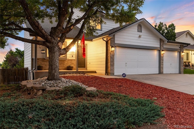 4304 S Genoa Ct, Centennial, CO 80015 - view of front facade featuring concrete driveway, an attached garage, and brick siding
