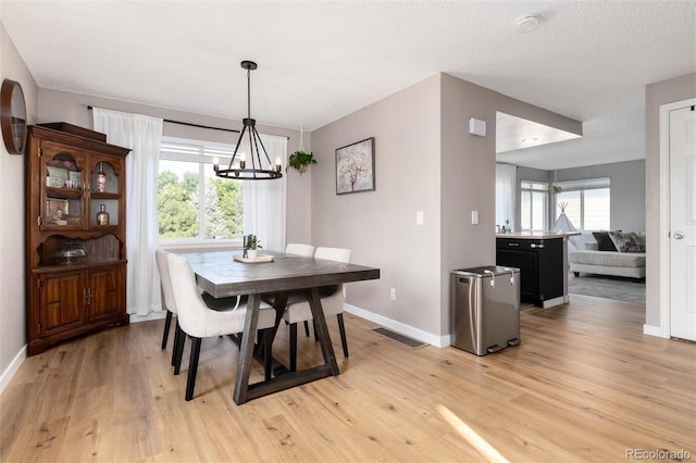 4304 S Genoa Ct, Centennial, CO 80015 - dining area with a chandelier and light wood-style flooring