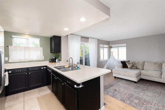 4304 S Genoa Ct, Centennial, CO 80015 - kitchen with open floor plan, dark cabinets, a peninsula, light countertops, and healthy amount of natural light