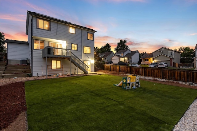 4304 S Genoa Ct, Centennial, CO 80015 - back of property at dusk with stairs, a fenced backyard, and a residential view