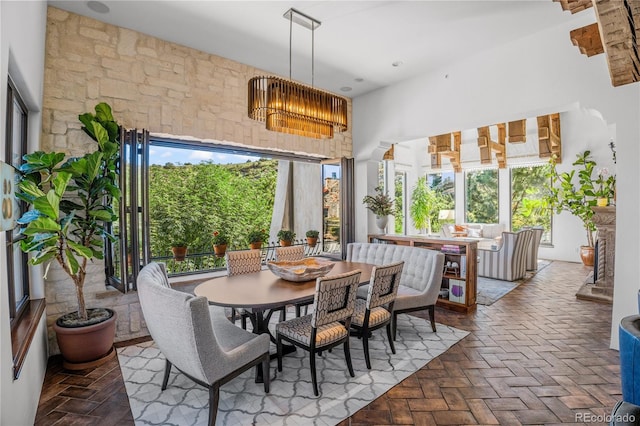 7944 Dante Dr, Littleton, CO 80125 - dining space featuring brick floor and a towering ceiling