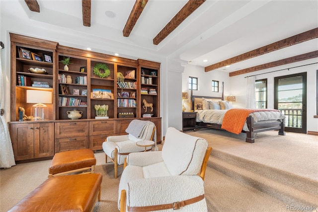 carpeted bedroom featuring access to outside and beam ceiling