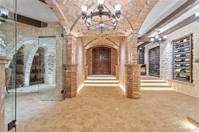 7944 Dante Dr, Littleton, CO 80125 - wine cellar featuring brick ceiling, beam ceiling, and a chandelier