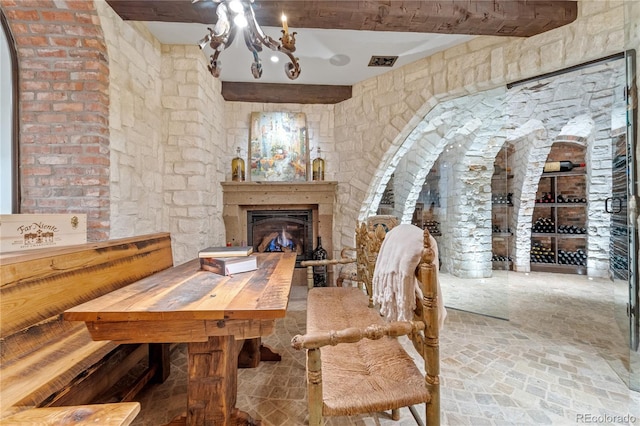 dining area featuring a chandelier and beam ceiling