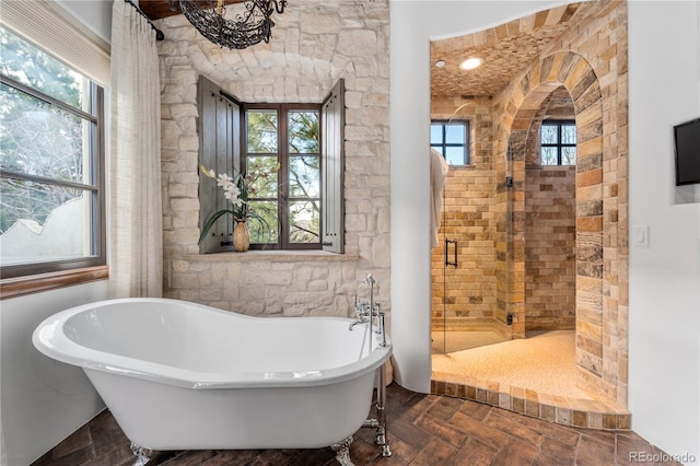 bathroom featuring shower with separate bathtub and plenty of natural light