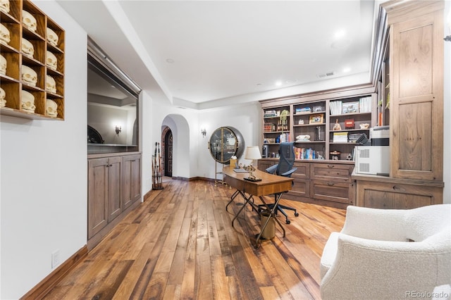 7944 Dante Dr, Littleton, CO 80125 - office with visible vents, baseboards, recessed lighting, arched walkways, and wood-type flooring
