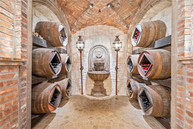 wine room featuring brick ceiling and brick wall