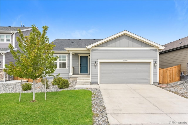 ranch-style home with a garage and a front lawn