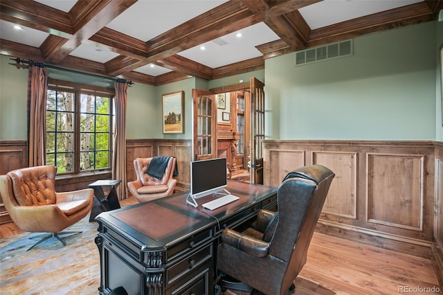 office space with wainscoting, beam ceiling, wood finished floors, coffered ceiling, and a decorative wall