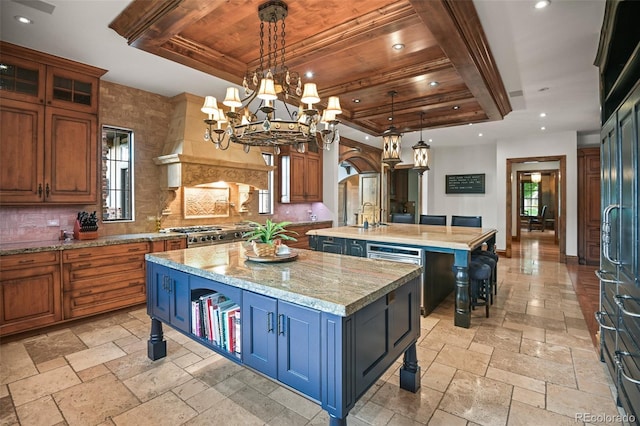 kitchen with a center island with sink, recessed lighting, stone tile flooring, tasteful backsplash, and wooden ceiling