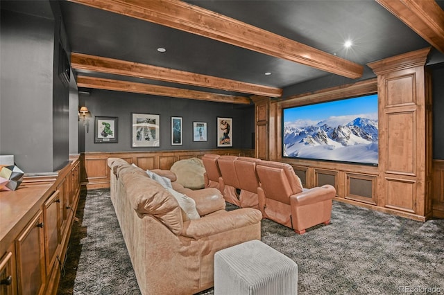 cinema room featuring dark carpet, beamed ceiling, a wainscoted wall, a decorative wall, and recessed lighting
