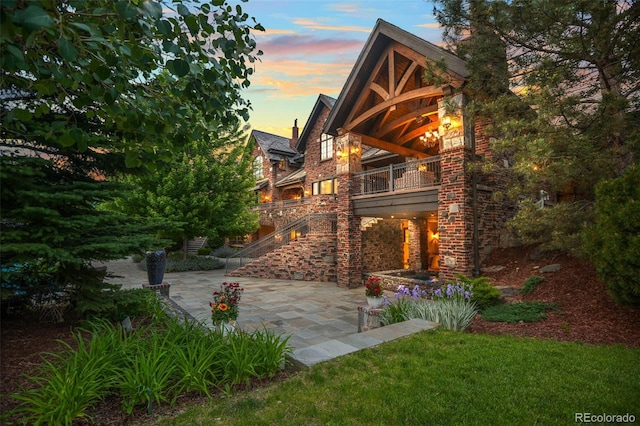 back of house featuring a patio and a balcony