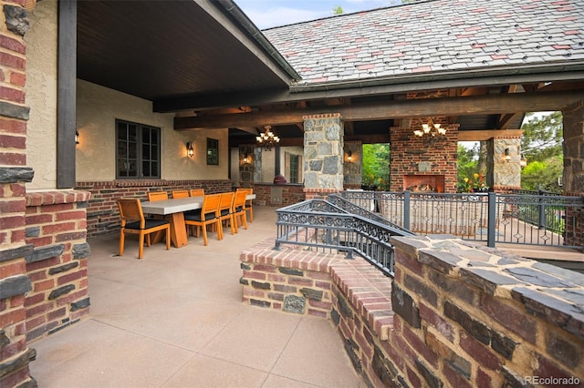 view of patio / terrace featuring an outdoor fireplace and outdoor dining area