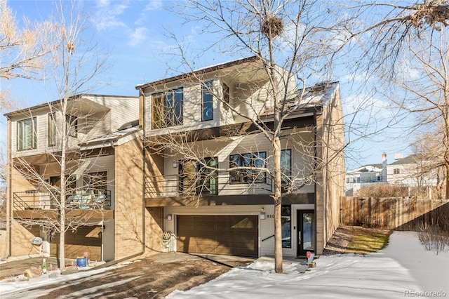 view of front of property with a garage and a balcony