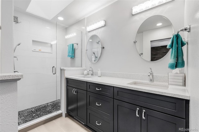 bathroom featuring vanity, tile patterned floors, and a shower with door