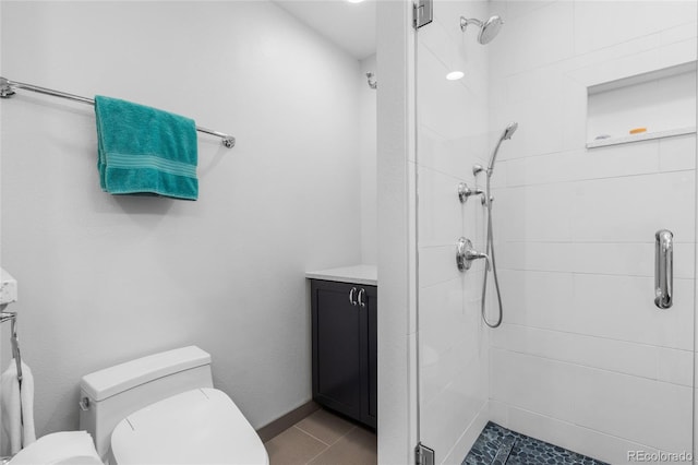 bathroom featuring vanity, an enclosed shower, tile patterned floors, and toilet