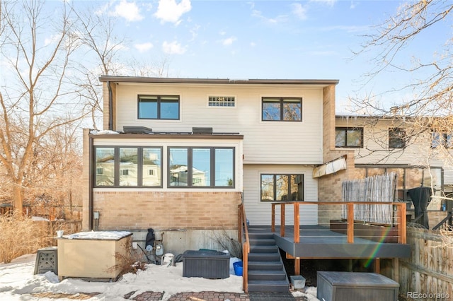 snow covered property with a wooden deck