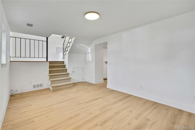 9605 Carr St, Broomfield, CO 80021 - unfurnished living room featuring wood finished floors, baseboards, and stairway