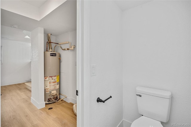 9605 Carr St, Broomfield, CO 80021 - bathroom with water heater, wood finished floors, and toilet