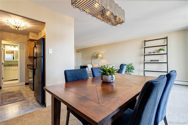 tiled dining room featuring sink