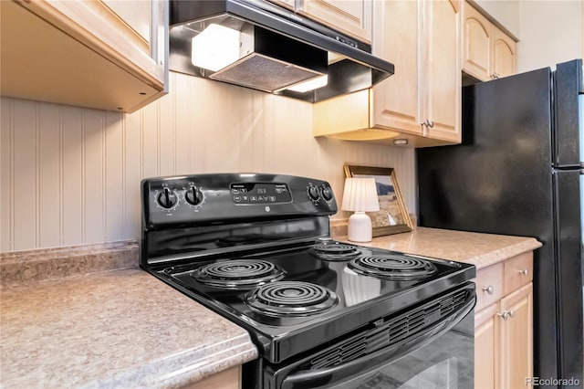 kitchen with wooden walls, light brown cabinetry, and black appliances