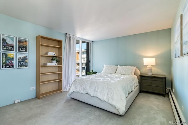 carpeted bedroom featuring baseboard heating