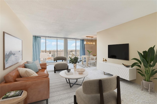 carpeted living room featuring a notable chandelier, a wall of windows, and a textured ceiling