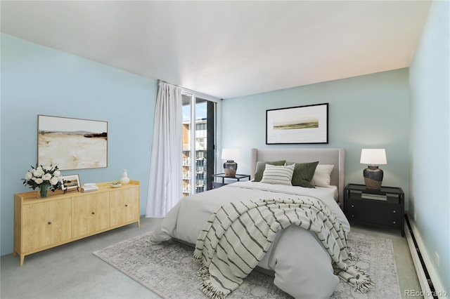 bedroom featuring expansive windows and baseboard heating