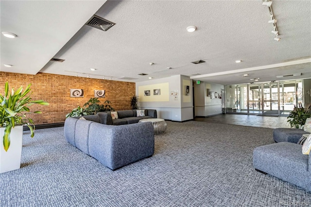 955 Eudora St Unit 708E, Denver, CO 80220 - building lobby with brick wall and a textured ceiling