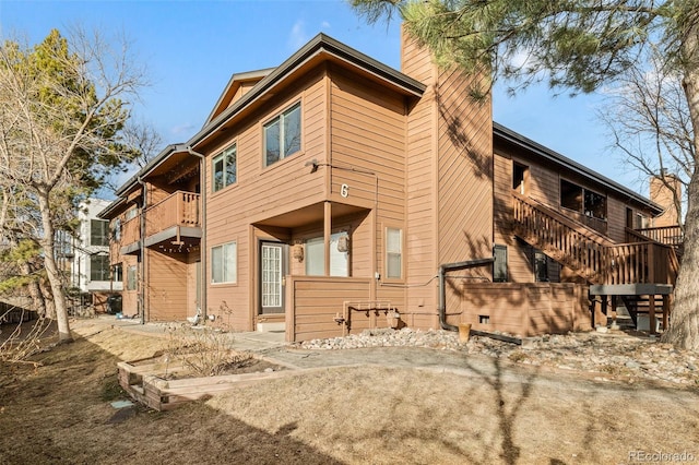 exterior space featuring stairs and a chimney