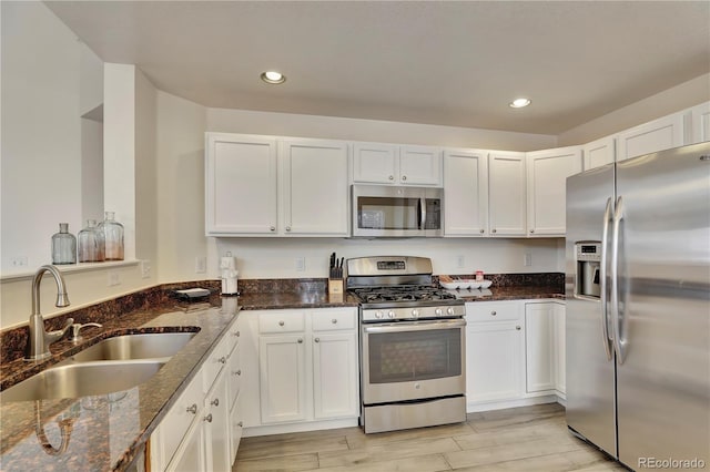 21541 Unbridled Ave, Parker, CO 80138 - kitchen with appliances with stainless steel finishes, a sink, white cabinets, and recessed lighting