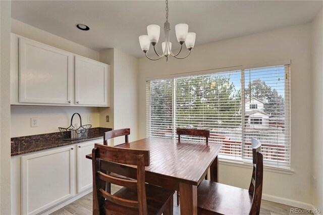 21541 Unbridled Ave, Parker, CO 80138 - dining space with a chandelier, plenty of natural light, and light wood-style flooring