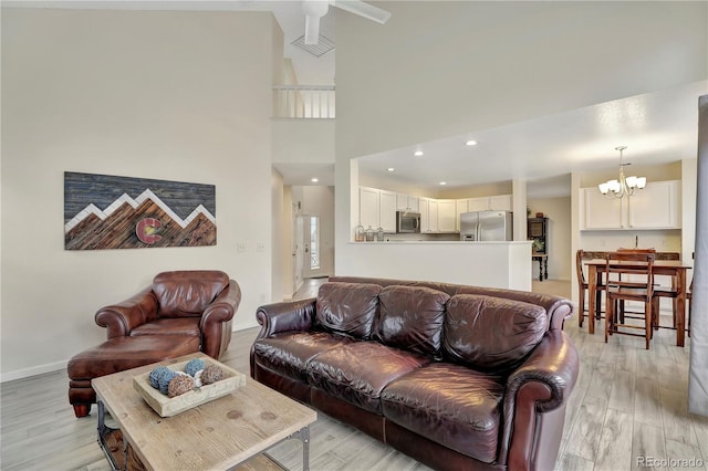21541 Unbridled Ave, Parker, CO 80138 - living area featuring light wood finished floors, a chandelier, baseboards, and ceiling fan