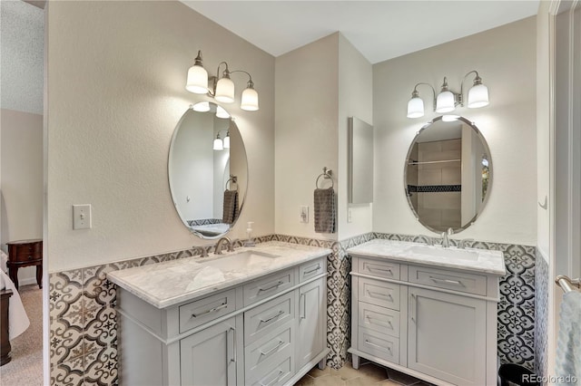 21541 Unbridled Ave, Parker, CO 80138 - full bathroom with two vanities and a wainscoted wall
