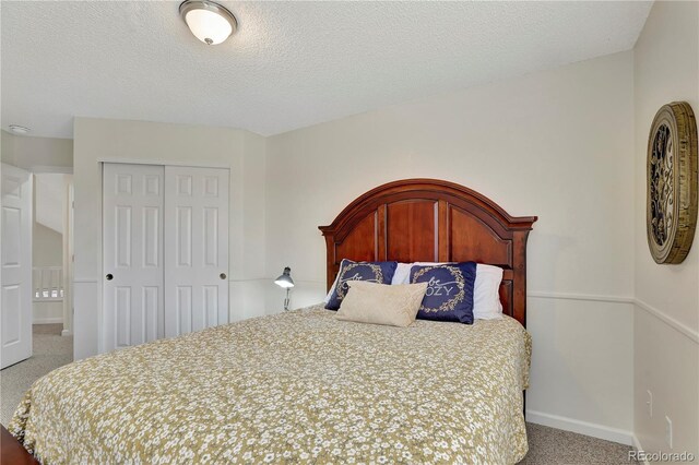 21541 Unbridled Ave, Parker, CO 80138 - bedroom featuring carpet, a closet, baseboards, and a textured ceiling