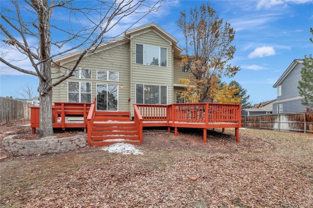 21541 Unbridled Ave, Parker, CO 80138 - back of house featuring a fenced backyard and a wooden deck
