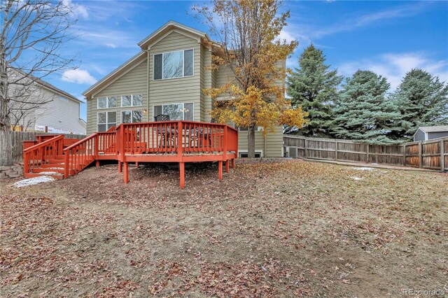 21541 Unbridled Ave, Parker, CO 80138 - rear view of property with a wooden deck and a fenced backyard