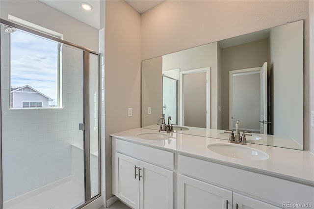 bathroom featuring vanity and an enclosed shower