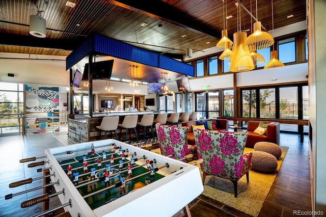 playroom with beam ceiling, wood ceiling, and high vaulted ceiling