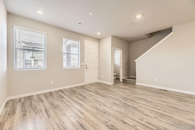 interior space with recessed lighting, light wood-type flooring, visible vents, and baseboards