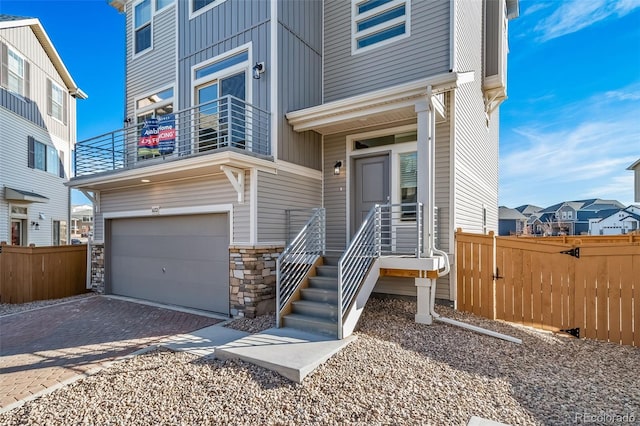 view of front of property with a balcony and a garage