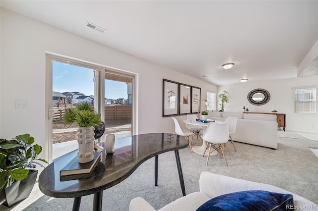 carpeted dining room featuring a healthy amount of sunlight