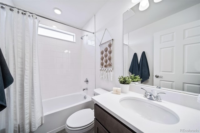 full bathroom with shower / bath combination with curtain, vanity, and toilet