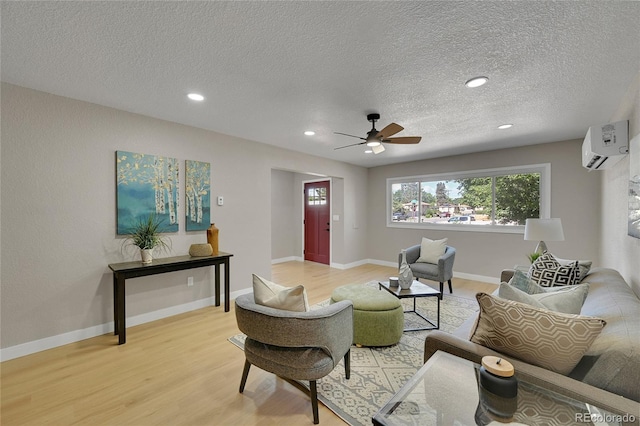 1596 S Stuart St, Denver, CO 80219 - living area with a wall mounted air conditioner, light wood-style flooring, a ceiling fan, a textured ceiling, and recessed lighting