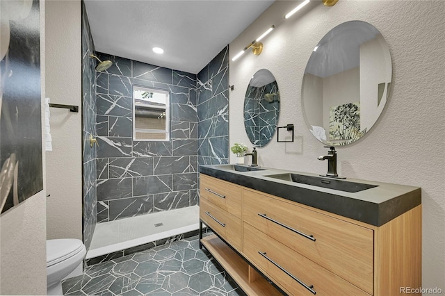 1596 S Stuart St, Denver, CO 80219 - full bathroom featuring double vanity, tiled shower, and a textured wall
