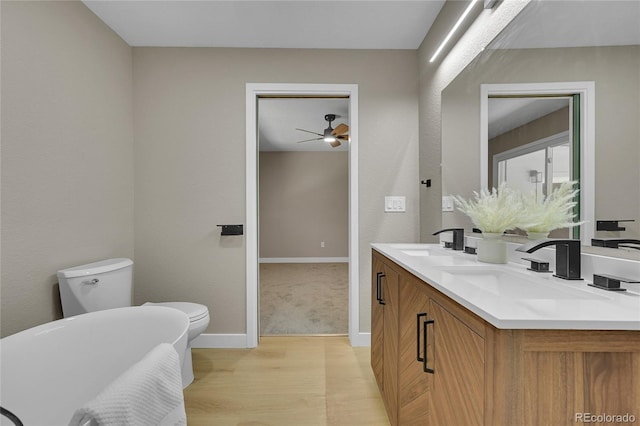 1596 S Stuart St, Denver, CO 80219 - bathroom with double vanity, wood finished floors, ceiling fan, and a soaking tub