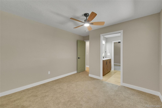 1596 S Stuart St, Denver, CO 80219 - unfurnished bedroom featuring light carpet, a ceiling fan, and a textured ceiling